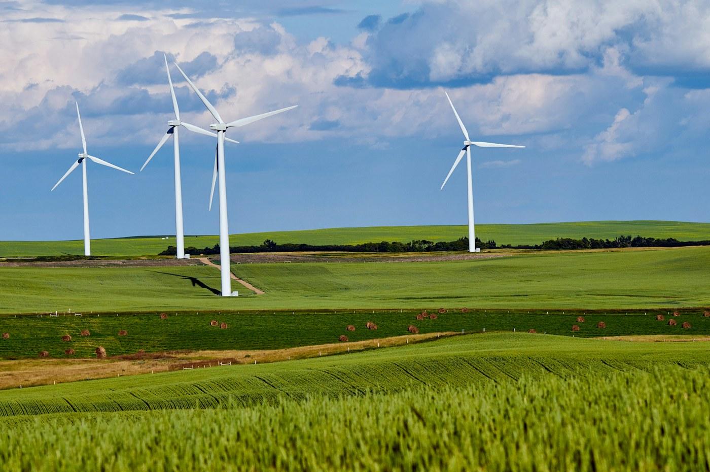 Wind turbines over green fields