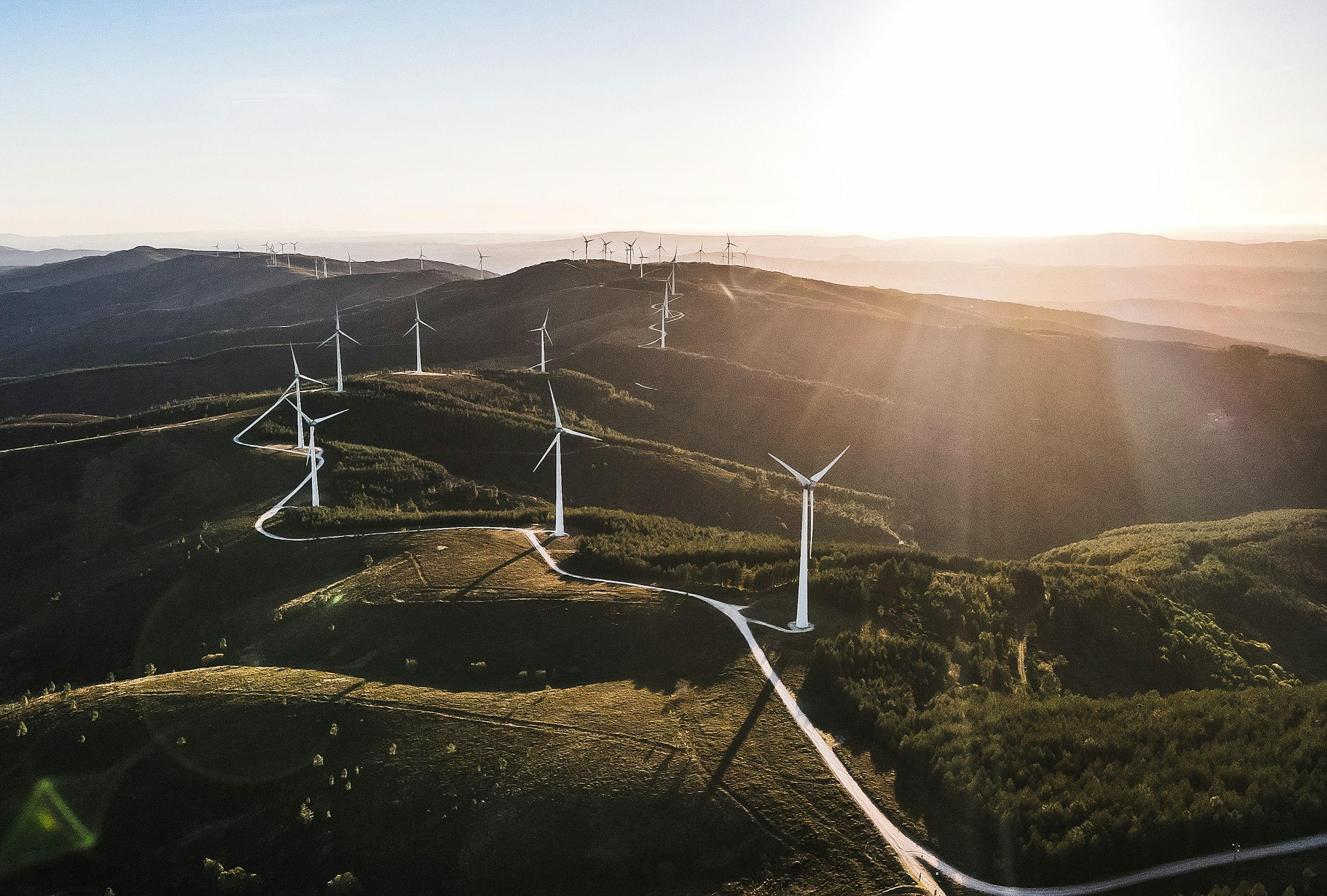 Wind turbines along a mountain ridge at sunrise, Serra da Lousã, Portugal